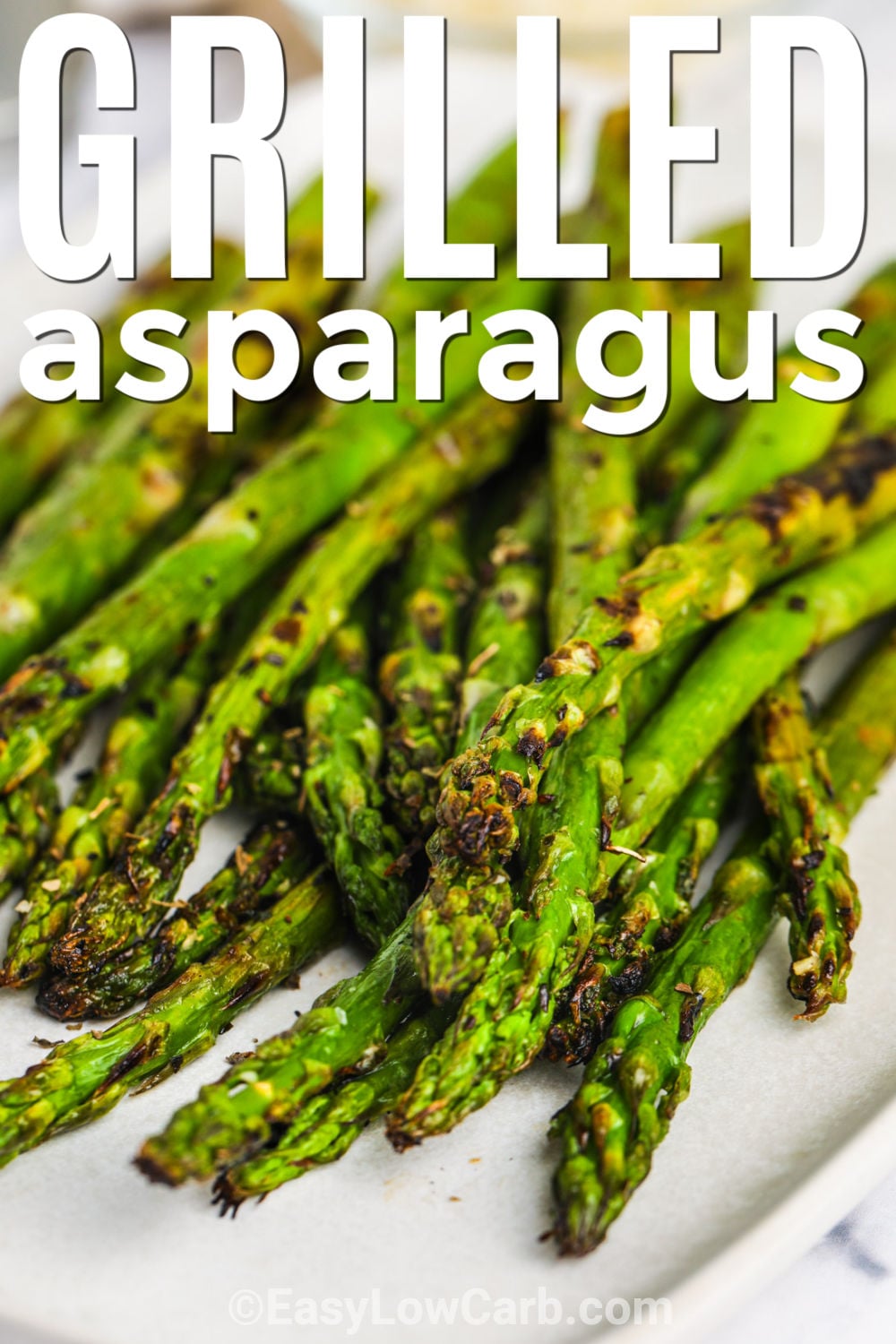 Grilled asparagus recipe is a simple way to make a vegetable side dish everyone will love. Fresh asparagus is tossed with olive oil, lemon juice, salt, and pepper, then grilled until tender with lightly browned edges. The lemon adds a bright finish that makes every bite fresh and flavorful. Serve it with chicken, steak, seafood, or your favorite summer meal. Give this easy grilled asparagus a try today and see how quickly it becomes a favorite. #easylowcarb close up of Grilled Asparagus Recipe