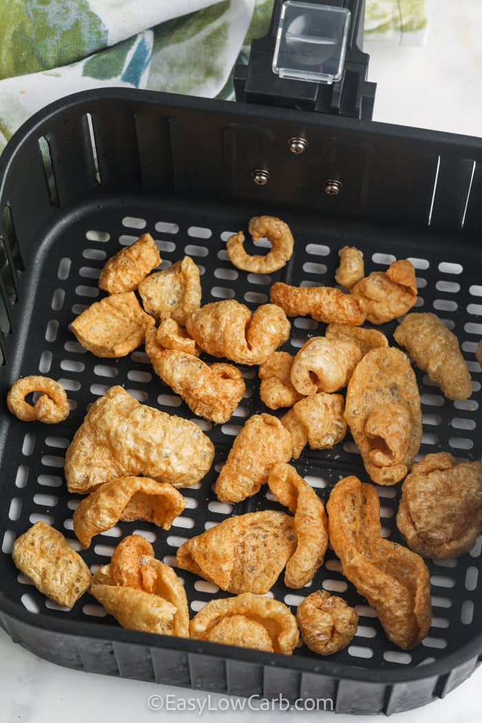 Pork rinds are the perfect base for this flavorful ranch snack that is made in the air fryer. Warming them brings out even more crunch while the seasonings coat every bite with bold flavor. This easy keto snack is perfect for parties, holiday gatherings, or keeping cravings in check with a satisfying low carb option. Save this recipe and make a batch soon. #easylowcarb pork rinds in the air fryer basket