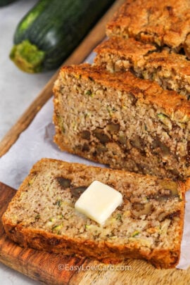 sliced Keto Zucchini Bread and one piece with butter on top