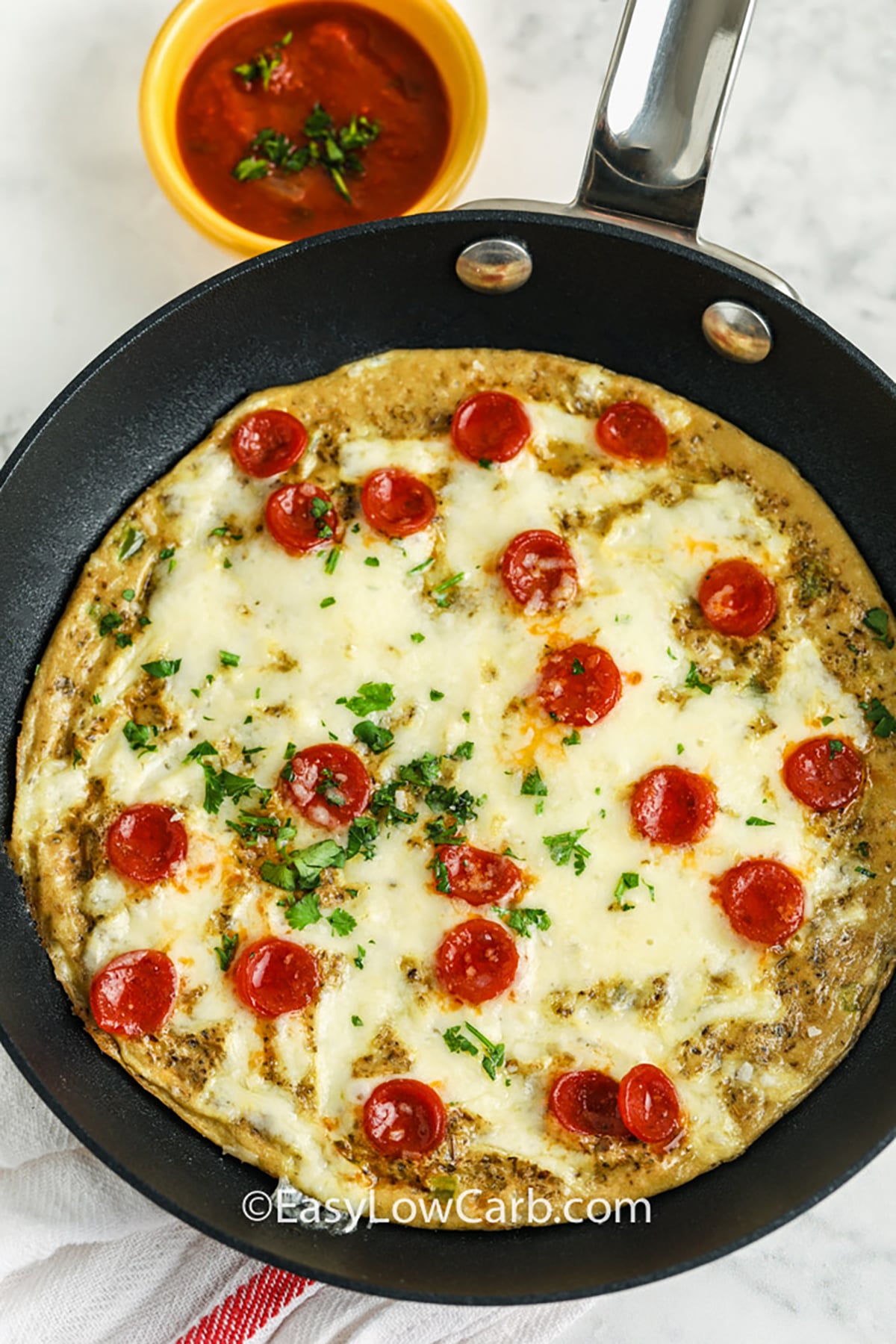 This keto breakfast pizza combines tender eggs, savory pepperoni, oregano, and bubbling mozzarella in one small skillet. The egg mixture becomes a sturdy base, so there is no flour, almond flour, or dough to prepare. Add mushrooms or green pepper for extra pizza flavor and keep low-carb tomato sauce on the side for dipping. It is an easy 15-minute breakfast with minimal prep and cleanup. Add this recipe to your keto breakfast board. #easylowcarb Keto Breakfast Pizza cooked in the pan