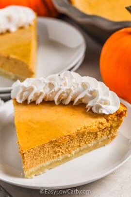 plated slices of Keto Pumpkin Cheesecake with whipped cream.