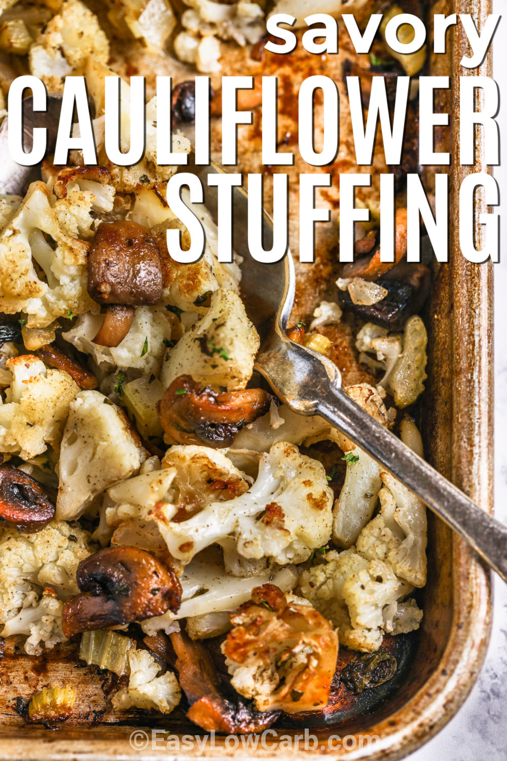 This cauliflower stuffing recipe turns everyday vegetables into a warm, savory side that fits right into a holiday menu. Cauliflower and mushrooms develop deeper flavor as they roast, while celery and onion add familiar stuffing character. Butter, rosemary, parsley, and poultry seasoning pull everything together with cozy flavor in every bite. Keep this low carb holiday side handy and save the recipe for your next roast dinner. #easylowcarb sheet pan of savory Cauliflower Stuffing with a title.