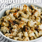 bowl of Cauliflower Stuffing with gravy and writing.