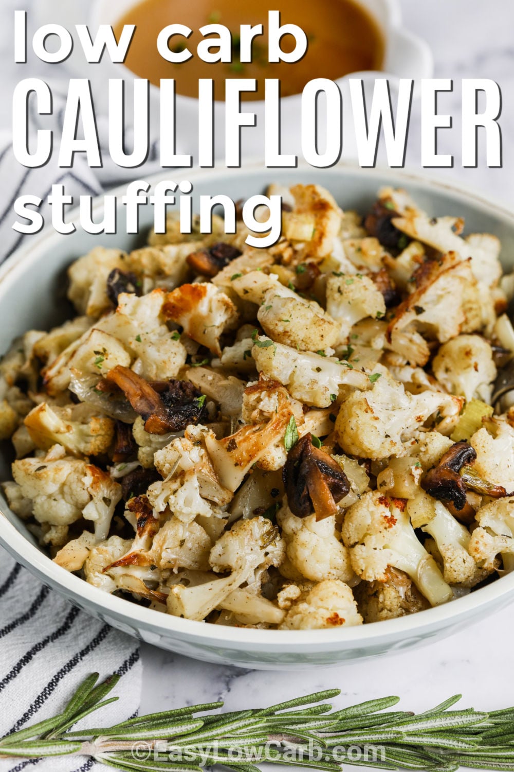 Low carb cauliflower Thanksgiving stuffing can still deliver the buttery herbs and comforting flavor everyone expects from a holiday side. This version combines bite-sized cauliflower with mushrooms, celery, onion, poultry seasoning, parsley, and rosemary, then roasts everything until tender and lightly browned. Simple prep and one-pan cooking make holiday dinner easier. Save this cauliflower stuffing for Thanksgiving, Christmas, or Sunday dinner. #easylowcarb bowl of Cauliflower Stuffing with gravy and writing.