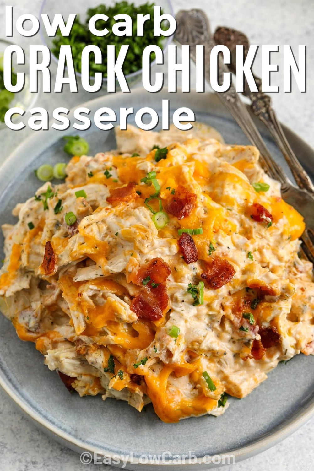 Crack chicken casserole is a comforting low-carb dinner loaded with tender chicken, crispy bacon, cheddar cheese, and creamy ranch-style flavor. The chicken is baked until tender, then shredded and combined with the creamy mixture before being topped with plenty of cheese, bacon, and green onion. Serve it with cauliflower rice or a fresh salad for a satisfying family meal. Give this easy chicken casserole a try tonight. #easylowcarb low carb Crack Chicken Casserole with writing.