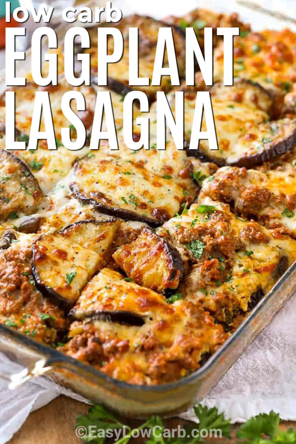 This eggplant lasagna recipe makes a hearty low-carb dinner layered with roasted eggplant, savory ground beef, ricotta, spinach, and mozzarella. It has all the comforting flavors of traditional lasagna without the pasta noodles. The cheesy layers make every serving satisfying, while the eggplant adds extra vegetables to the meal. This protein-rich casserole is perfect for family dinners. Save this recipe and give it a try soon. #easylowcarb low carb Eggplant Lasagna in the casserole dish with writing.