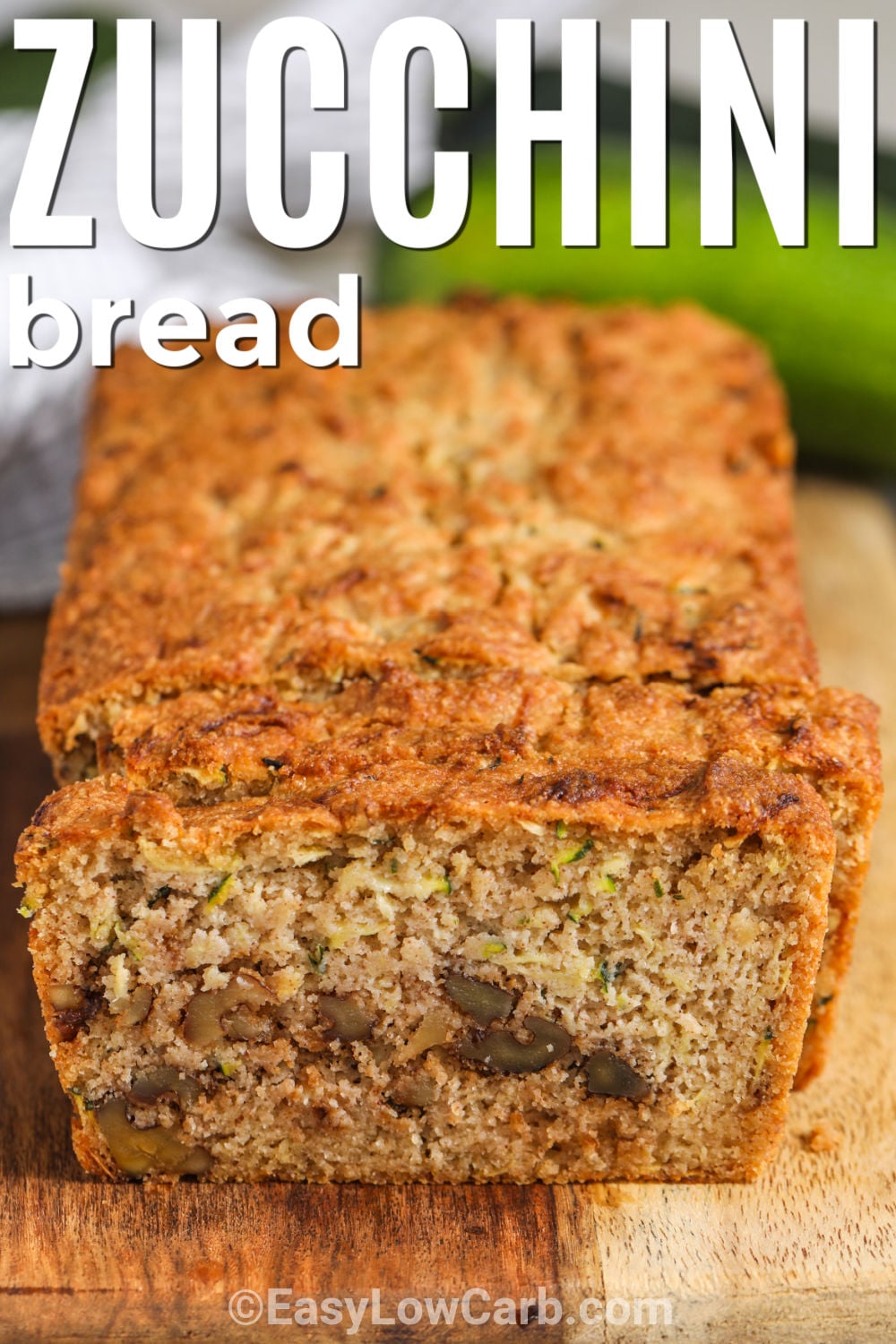 This keto zucchini bread makes a delicious low-carb breakfast or snack. Grated zucchini, almond flour, butter, and warm cinnamon come together in a simple loaf that the whole family can enjoy. Add walnuts for extra crunch or leave them out for a nut-free option. It is easy to slice, serve, and freeze for another day. Give this homemade zucchini bread a try today. #easylowcarb loaf of Keto Zucchini Bread with a title
