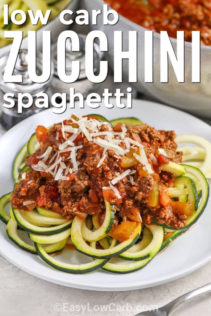 Try zucchini spaghetti when you want a comforting dinner without traditional pasta. Fresh zucchini noodles are topped with a flavorful meat sauce made with ground beef, tomatoes, garlic, onion, and Italian seasoning. Parmesan cheese adds a savory finish to every serving. This easy low-carb recipe is simple enough for busy nights and hearty enough to satisfy the whole family. #easylowcarb Zucchini Spaghetti with meat sauce and writing.