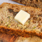 close up of a slice of Keto Zucchini Bread with butter