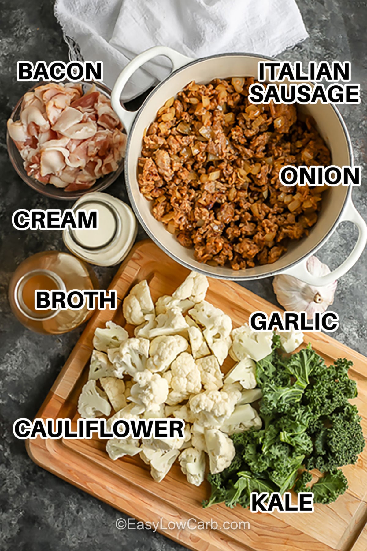 For a comforting dinner, Keto Zuppa Toscana delivers plenty of rich, savory flavor. This creamy low carb soup is loaded with Italian sausage, bacon, cauliflower, kale, and garlic. The vegetables make it hearty, while chicken broth and cream create a satisfying base that brings everything together. It is a wonderful choice when you want homemade comfort food without the potatoes. Add crispy bacon to each bowl and enjoy. Try this recipe today. #easylowcarb bacon, Italian sausage , onion , cream , broth , cauliflower , garlic , kale with labels to make Keto Zuppa Toscana.