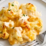 Cheesy Cauliflower Casserole on a plate with a fork.