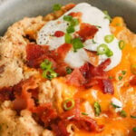 close up of cheesy Twice Baked Cauliflower Casserole.